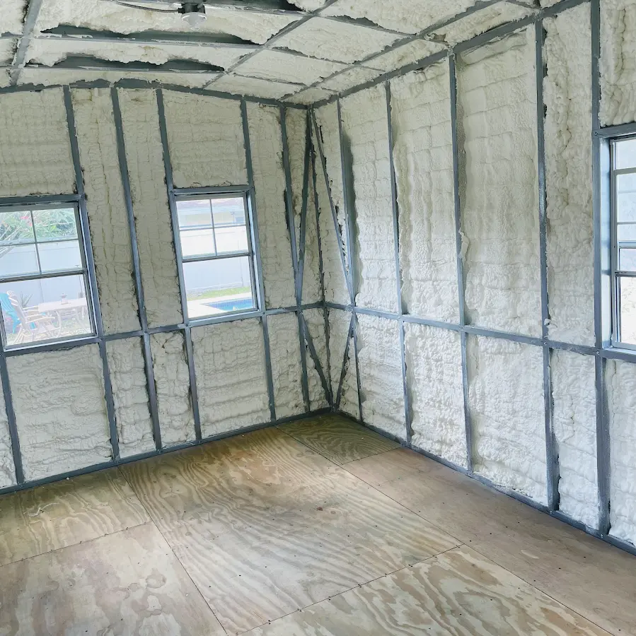 Closed-cell spray foam insulation applied to wall cavities in a residential project in Corcoran